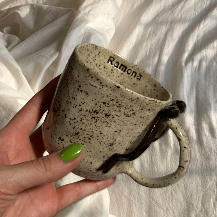 Handmade brown splashed bow mug