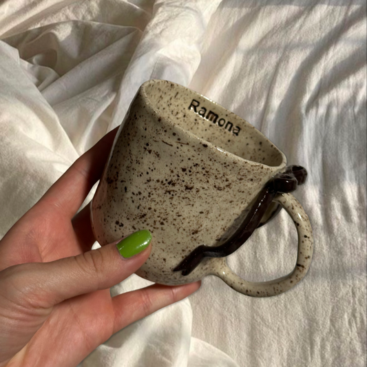 Handmade brown splashed bow mug